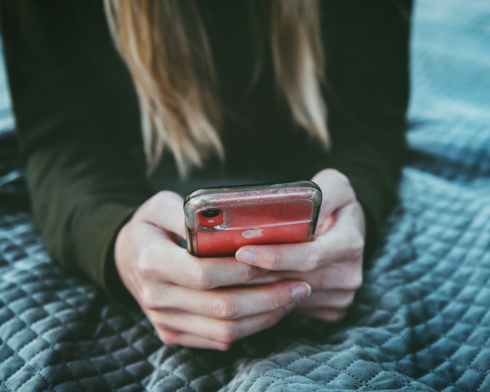 woman on her phone looking for negative keywords