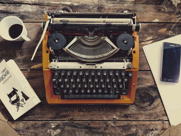 coloured typewriter on a rustic desktop