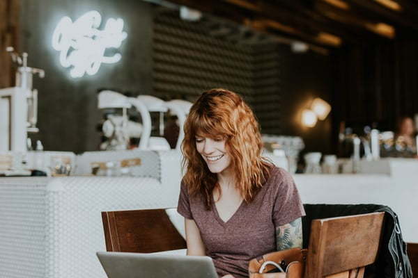 lady in coffee shop working on her laptop