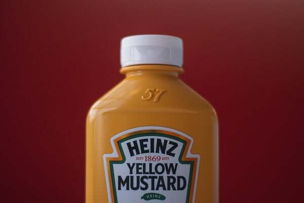 bottle of heinz yellow mustard with their well known branding and label