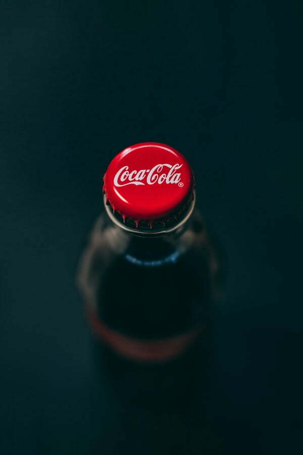 Coca Cola's iconic branding. Glass bottle viewed from the top.