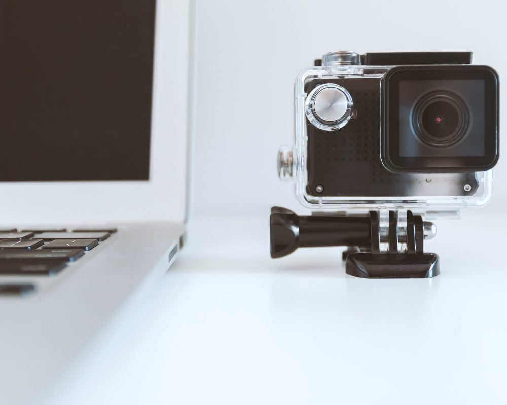 Go Pro camera set up by laptop, ready to record a video for marketing.