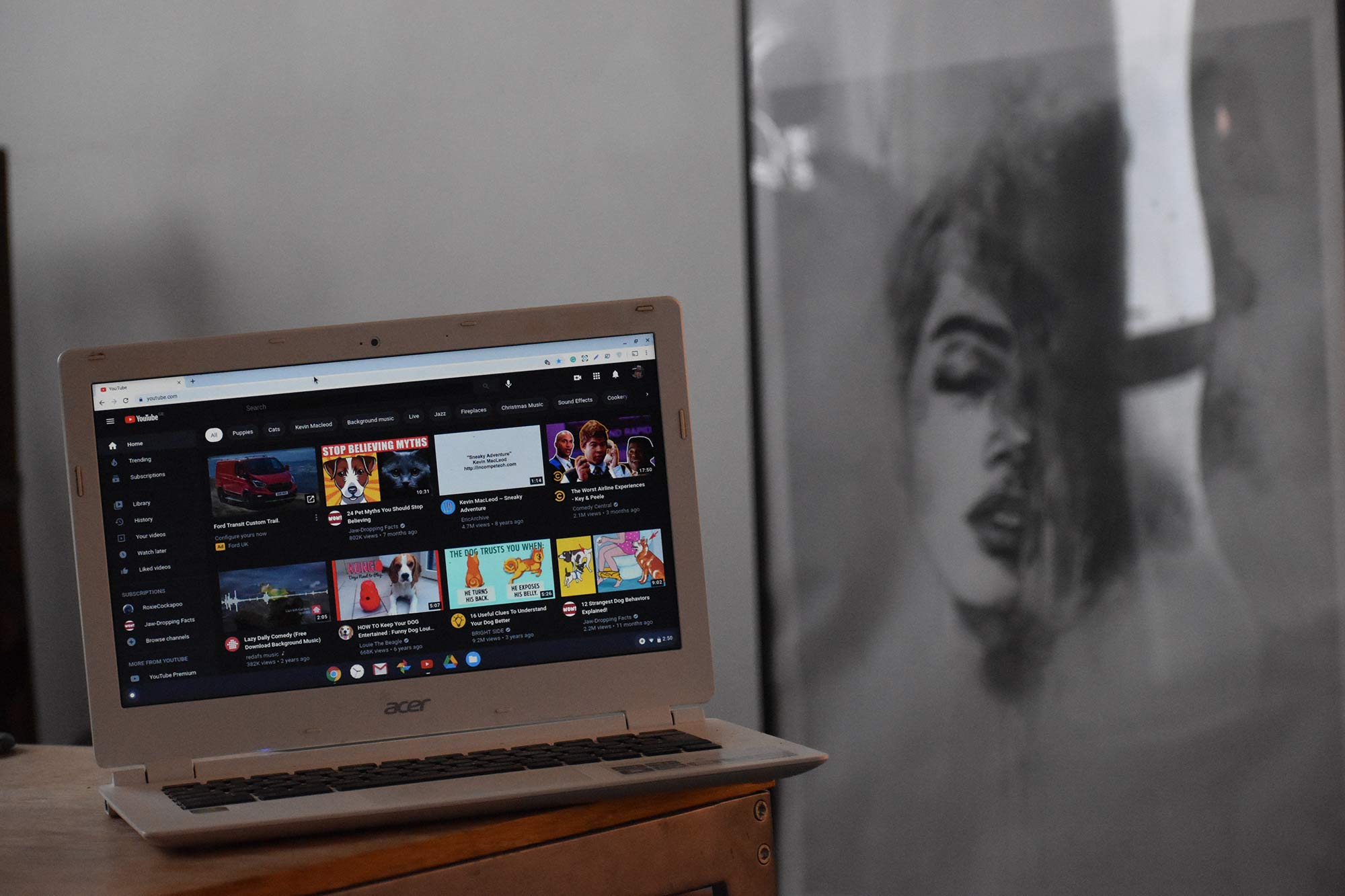 youtube-homepage-on-laptop-infront-of-artwork