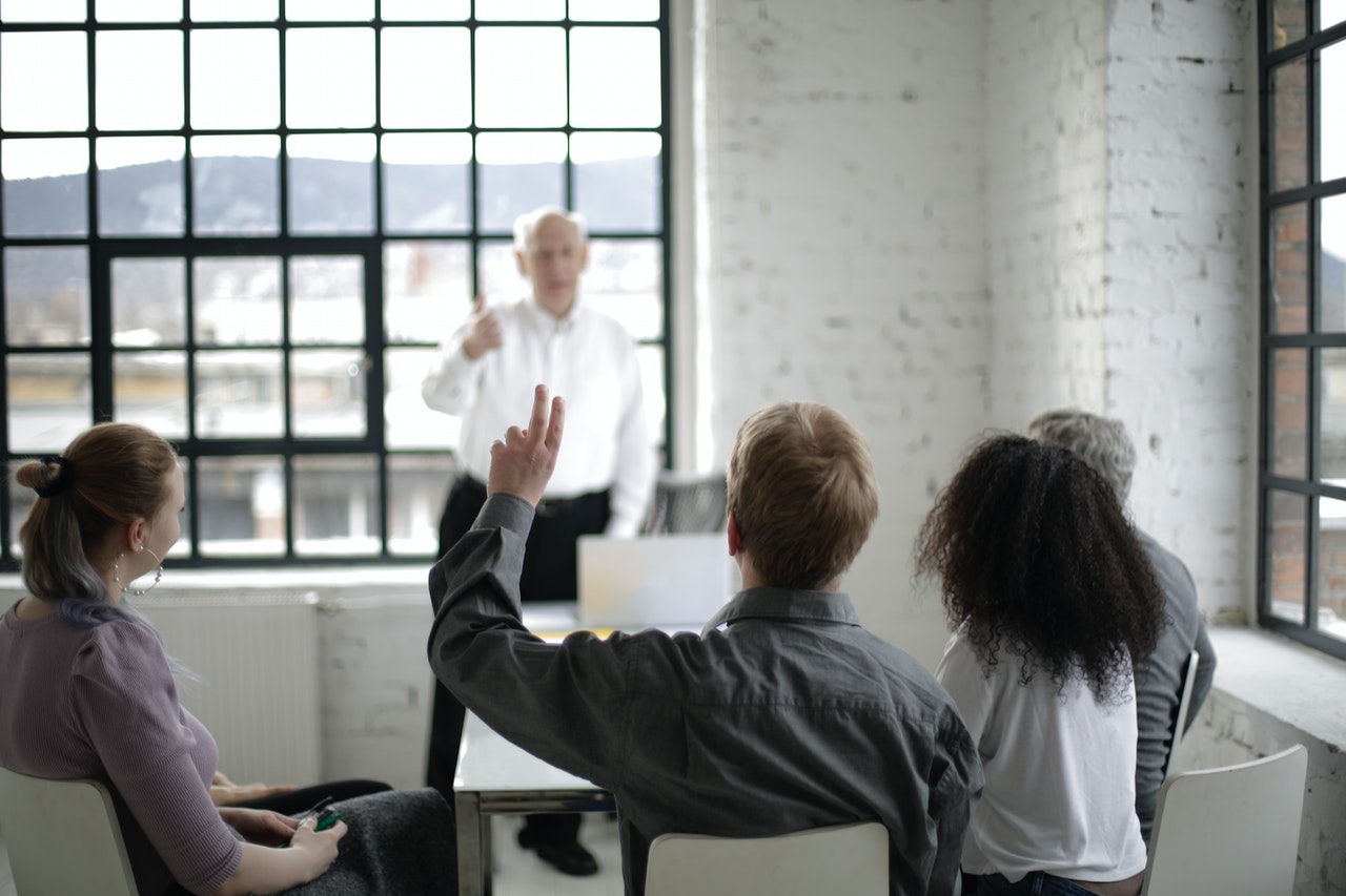 man-raising-hand-to-ask-a-question