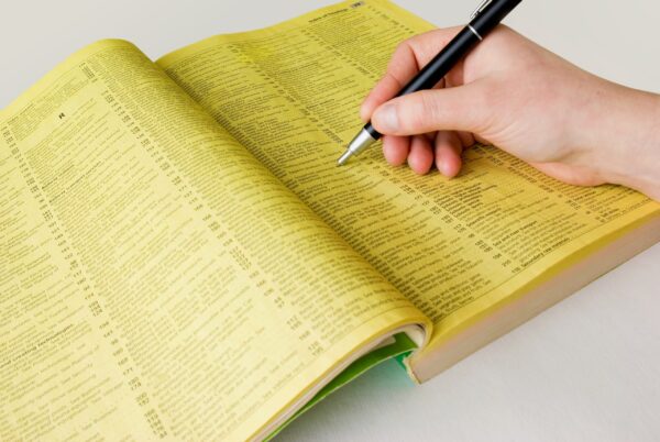 person-writing-in-a-phonebook